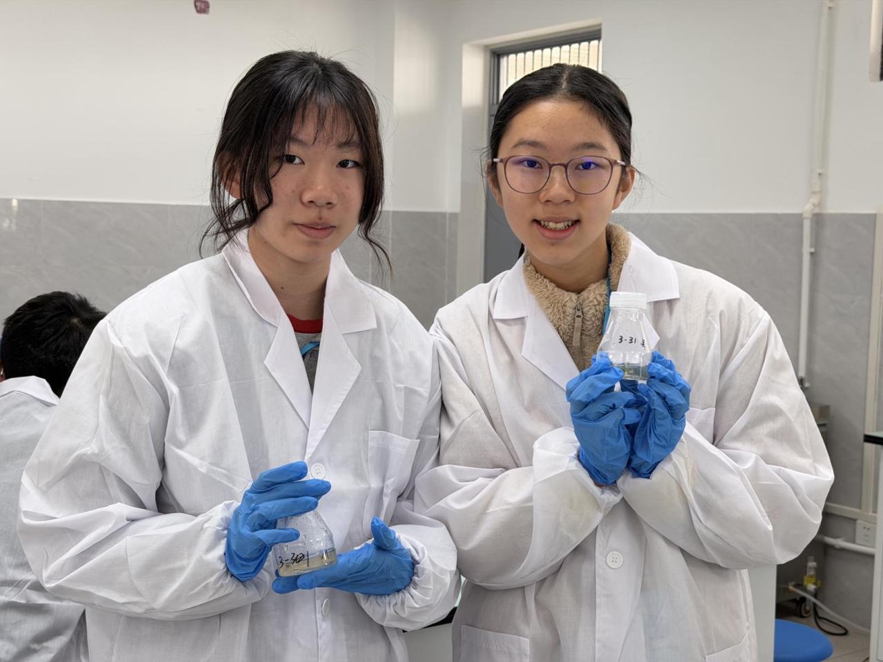 Students proudly presenting their plant tissue culture results.