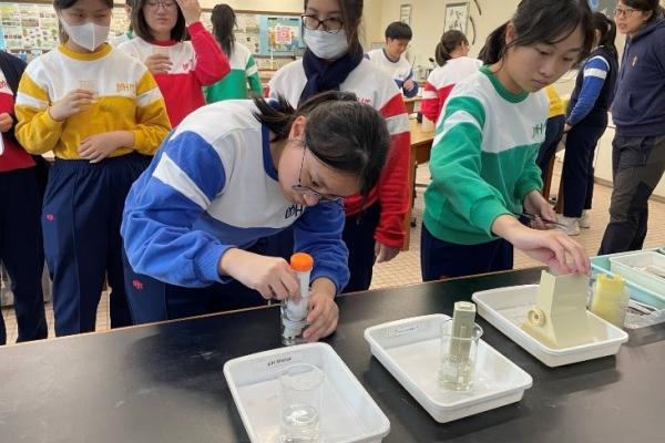 Students studying biology examine the samples they have obtained in the laboratory 